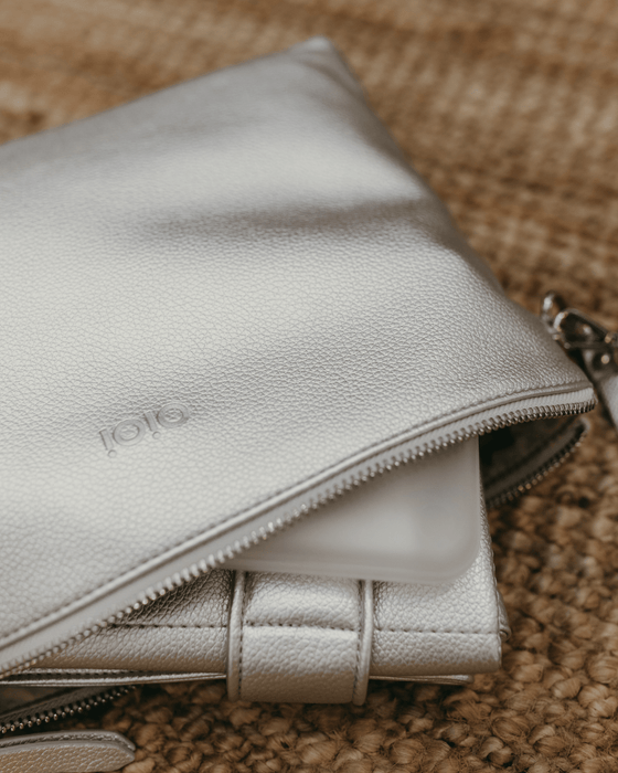 Packed in a spacious metallic silver nappy wallet is a matching fold-up change mat and wipes case.
