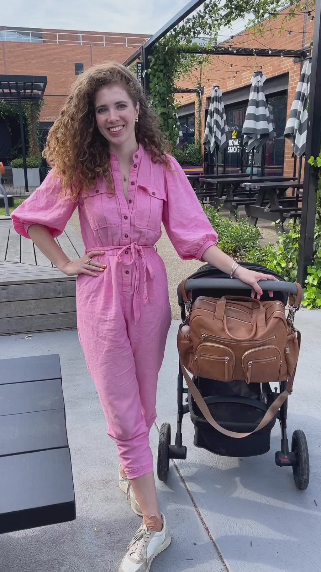 A mum demonstrates the OiOi carry all nappy bag